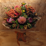 Bouquet in autumn shades wrapped in brown paper