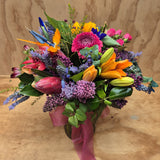 a colourful mix of flowers in glass vase