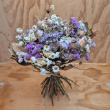 Bouquet of dried flowers in lilac and neutral tones. 