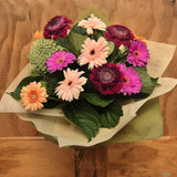 Bouquet of mixed gerberas on a wooden surface