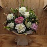 Bouquet of flowers in a water box with a wooden background.