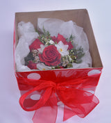 Boxed red and white wrist corsage