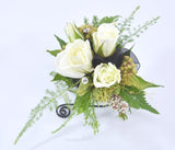 white mini roses, with black chiffon ribbon and a black bracelet and diamantes make an elegant wrist corsage