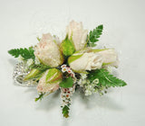 soft pink roses and foliage in a wrist corsage