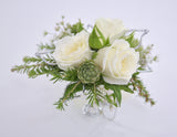 white rose wrist corsage with foliage and silver accent leaves